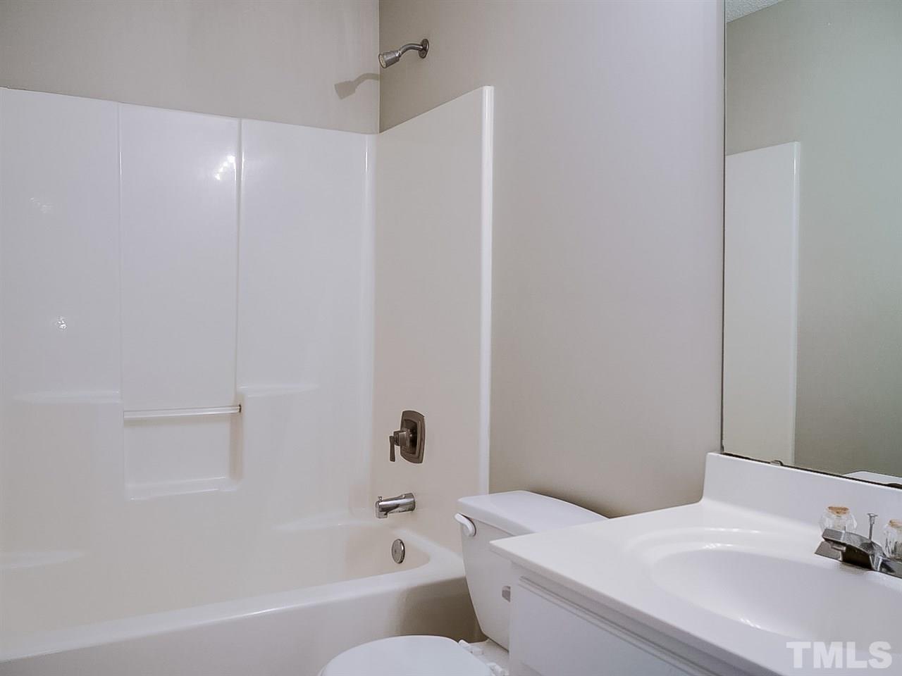 7416 Lowell Ridge Road Raleigh, NC 27616 - Photo 22 of 26 a bathroom with a sink and a bathtub