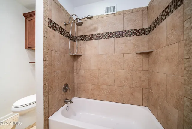a white bath tub sitting next to a white toilet