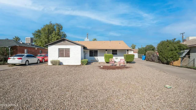 a view of a house with a patio and a yard