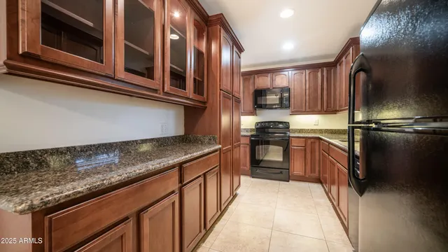 a kitchen with stainless steel appliances granite countertop a stove and a microwave