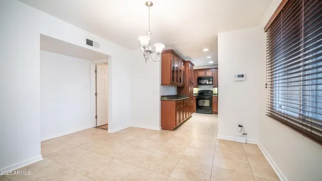 a view of a kitchen with refrigerator and a stove