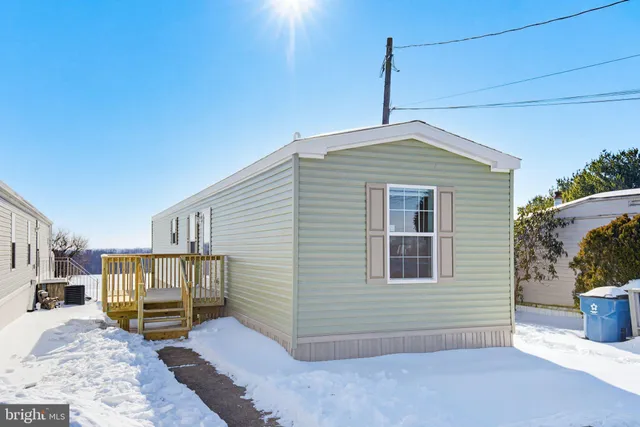 a backyard of a house with barbeque oven and potted plants