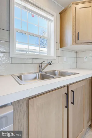 a kitchen with a sink and a window