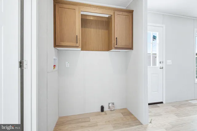 a view of a closet area with wooden floor
