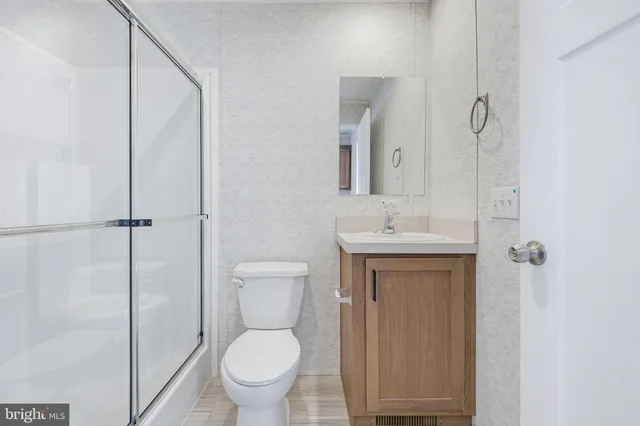 a bathroom with a toilet sink and a mirror