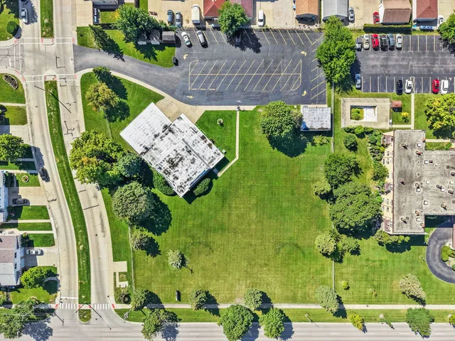 an aerial view of a residential apartment building with a yard