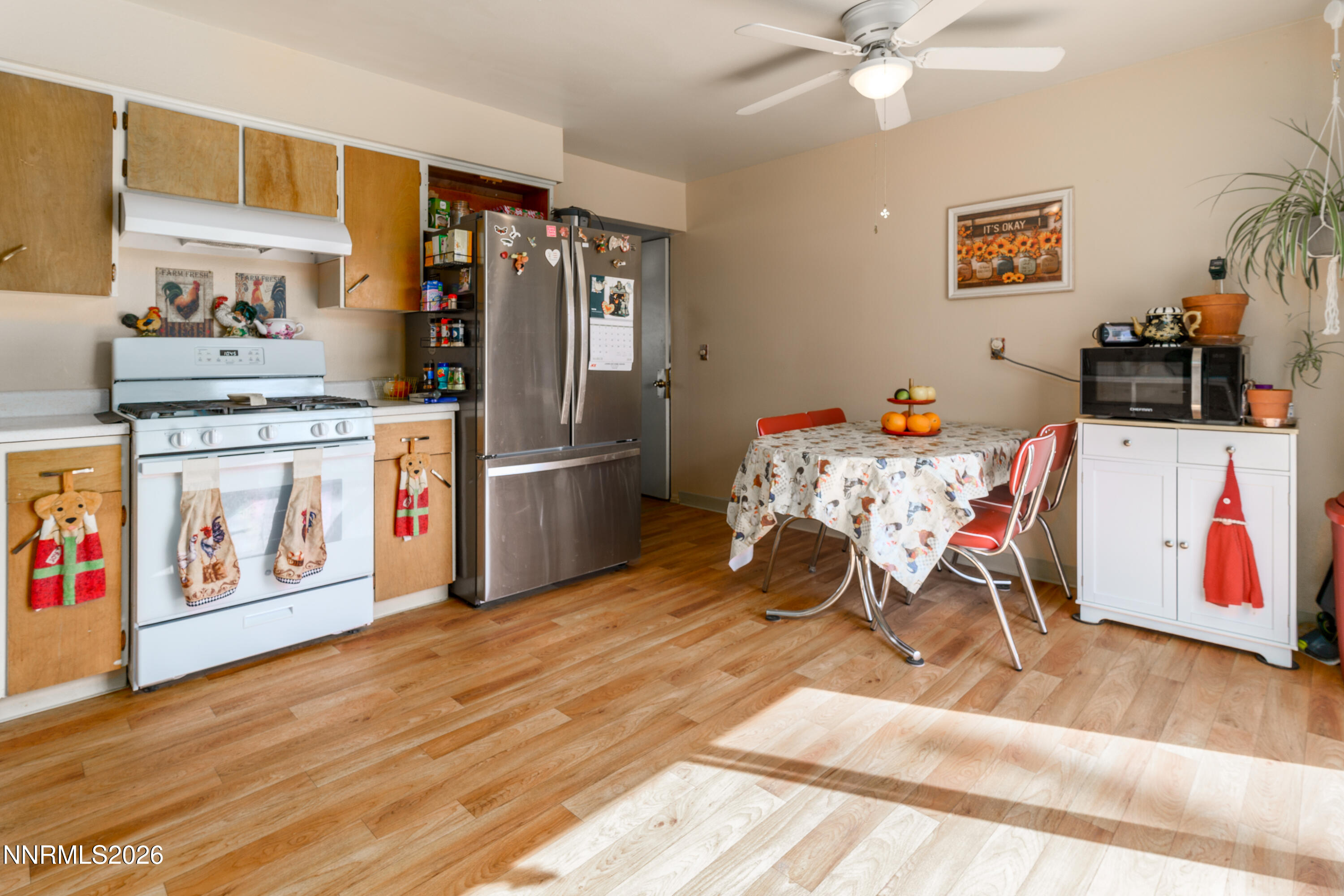 595 Cora Way Fallon, NV 89406 - Photo 11 of 23 a kitchen with stainless steel appliances wooden floor and cabinets