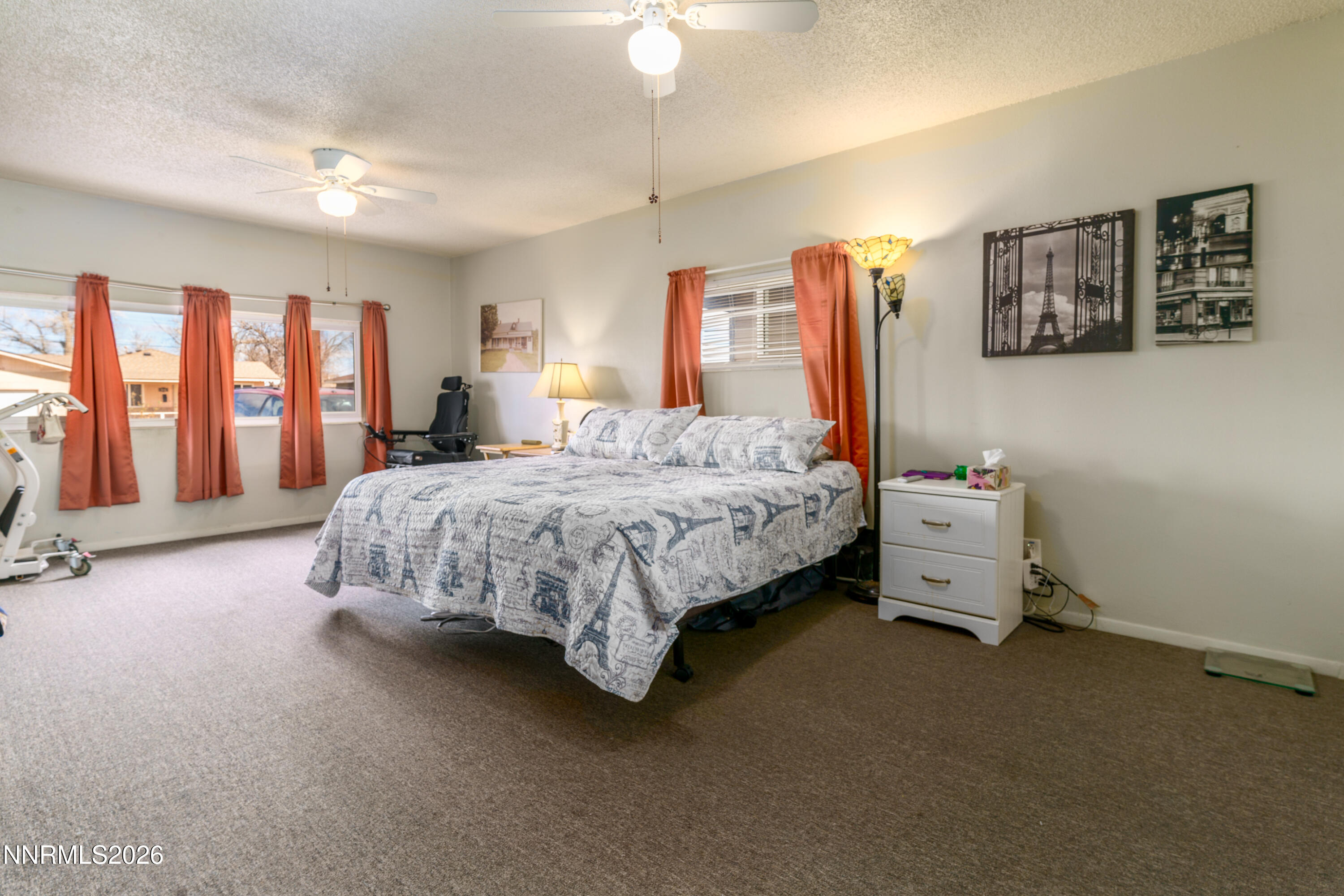 595 Cora Way Fallon, NV 89406 - Photo 12 of 23 a bedroom with a bed and a chandelier