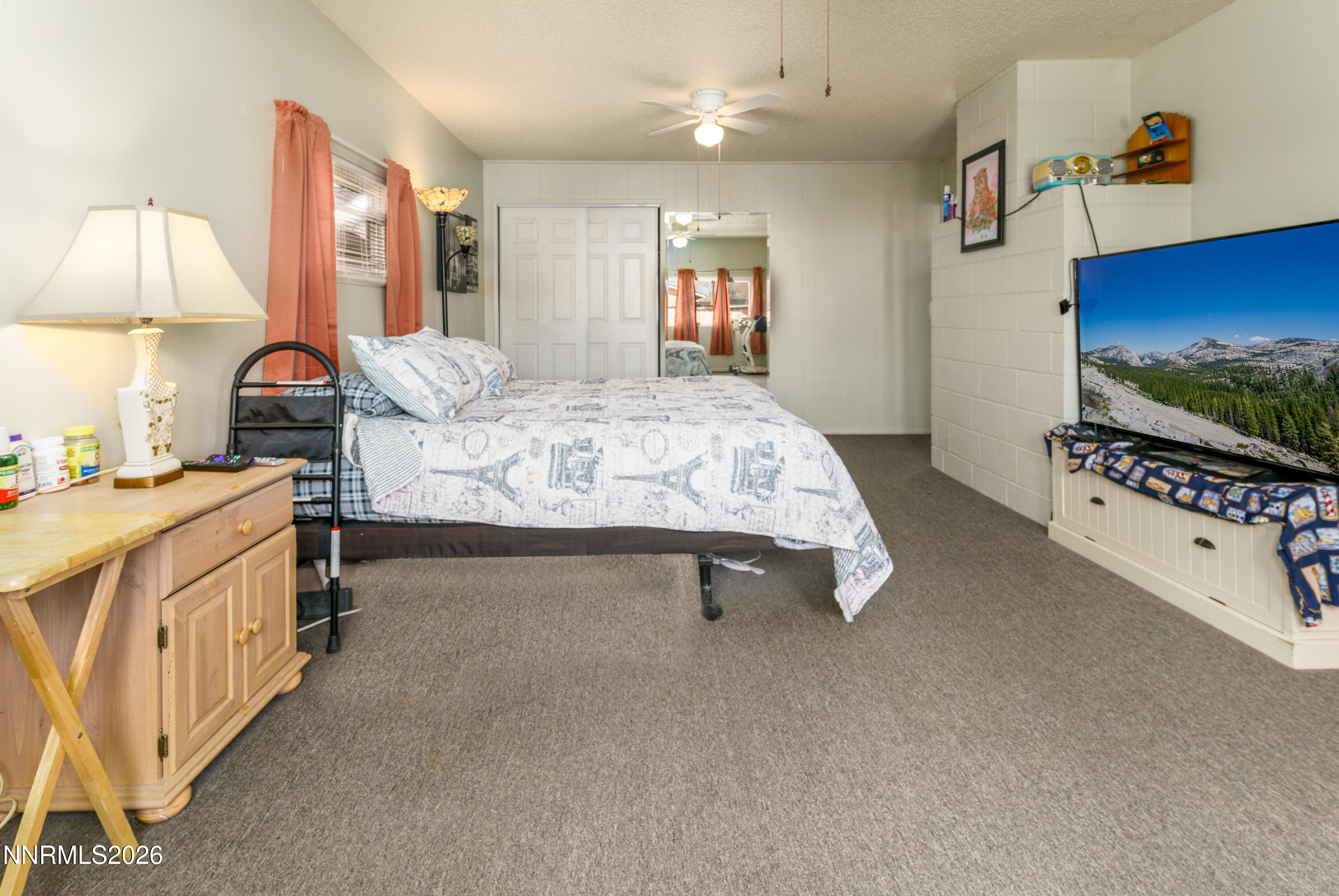 595 Cora Way Fallon, NV 89406 - Photo 13 of 23 a bed room with a bed and a flat tv screen on dresser