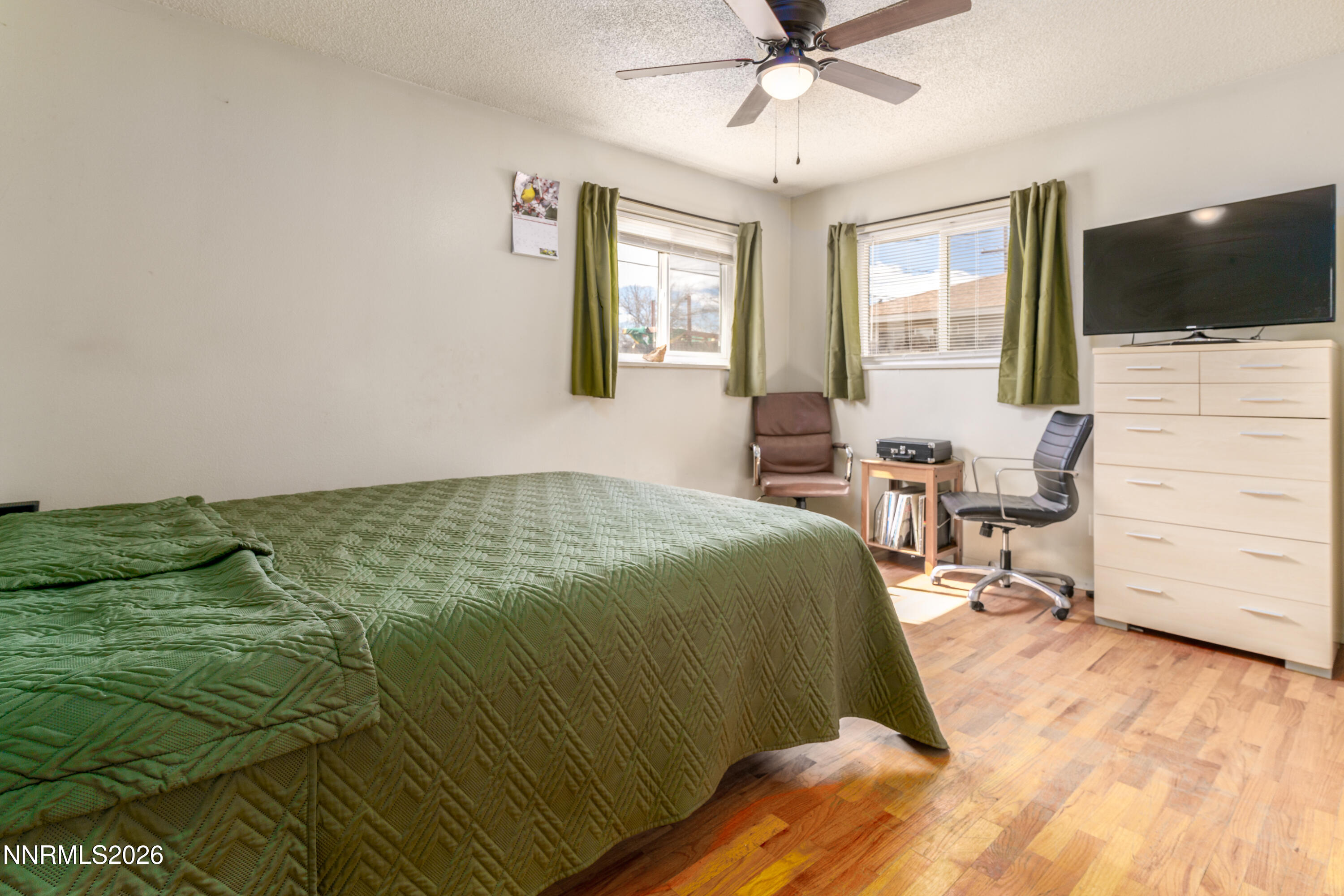 595 Cora Way Fallon, NV 89406 - Photo 15 of 23 a bedroom with a bed and a flat screen tv