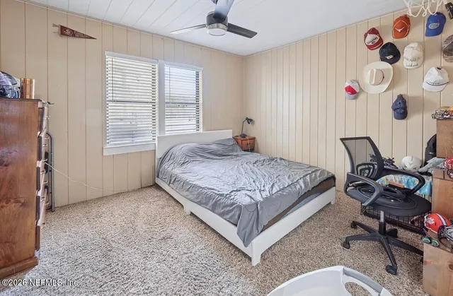 a bedroom with a bed and a dresser in it