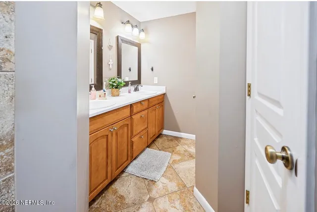 a bathroom with a double vanity sink and mirror
