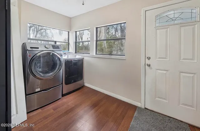 a view of a hallway with washer and dryer