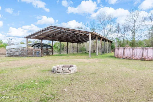 a backyard of a house with table and chairs