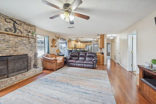 a living room with furniture fireplace and a flat screen tv