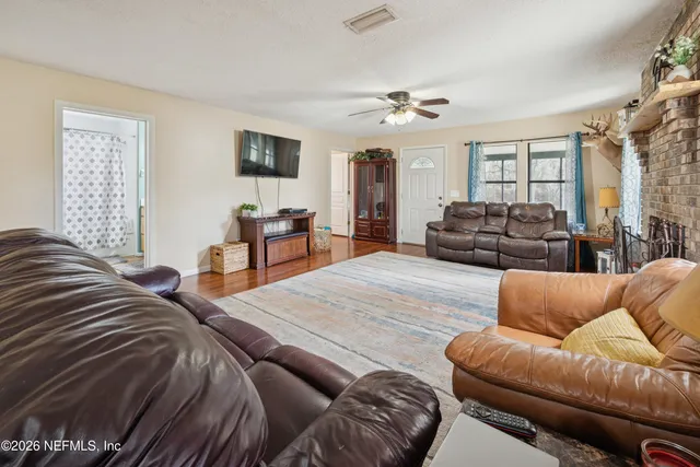 a bedroom with a bed couch and a window