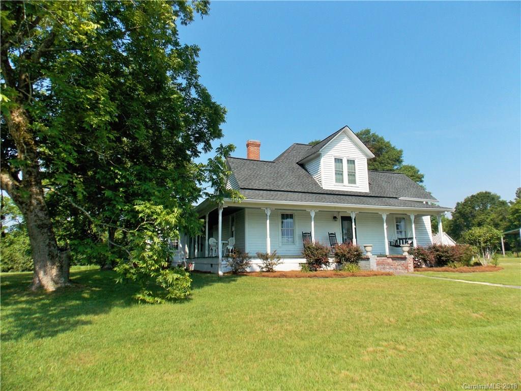 3242 South Potter Road Heath Springs, SC 29058 - Photo 2 of 33 a view of a white house with a big yard and a large tree