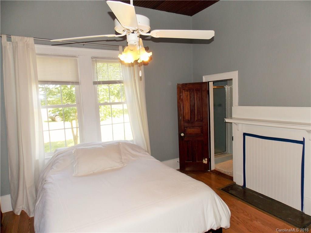 3242 South Potter Road Heath Springs, SC 29058 - Photo 11 of 33 a bedroom with a bed and a chandelier
