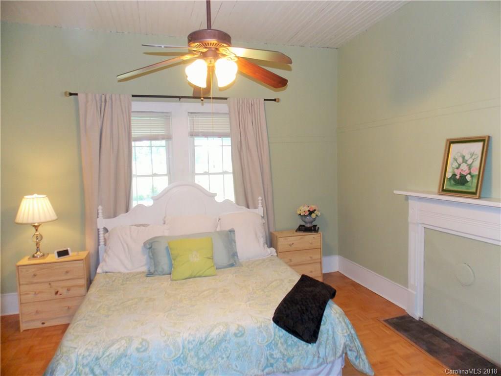 3242 South Potter Road Heath Springs, SC 29058 - Photo 14 of 33 a bedroom with a bed and a chandelier