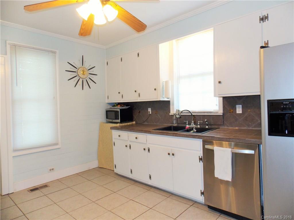 3242 South Potter Road Heath Springs, SC 29058 - Photo 19 of 33 a kitchen with granite countertop white cabinets and white appliances