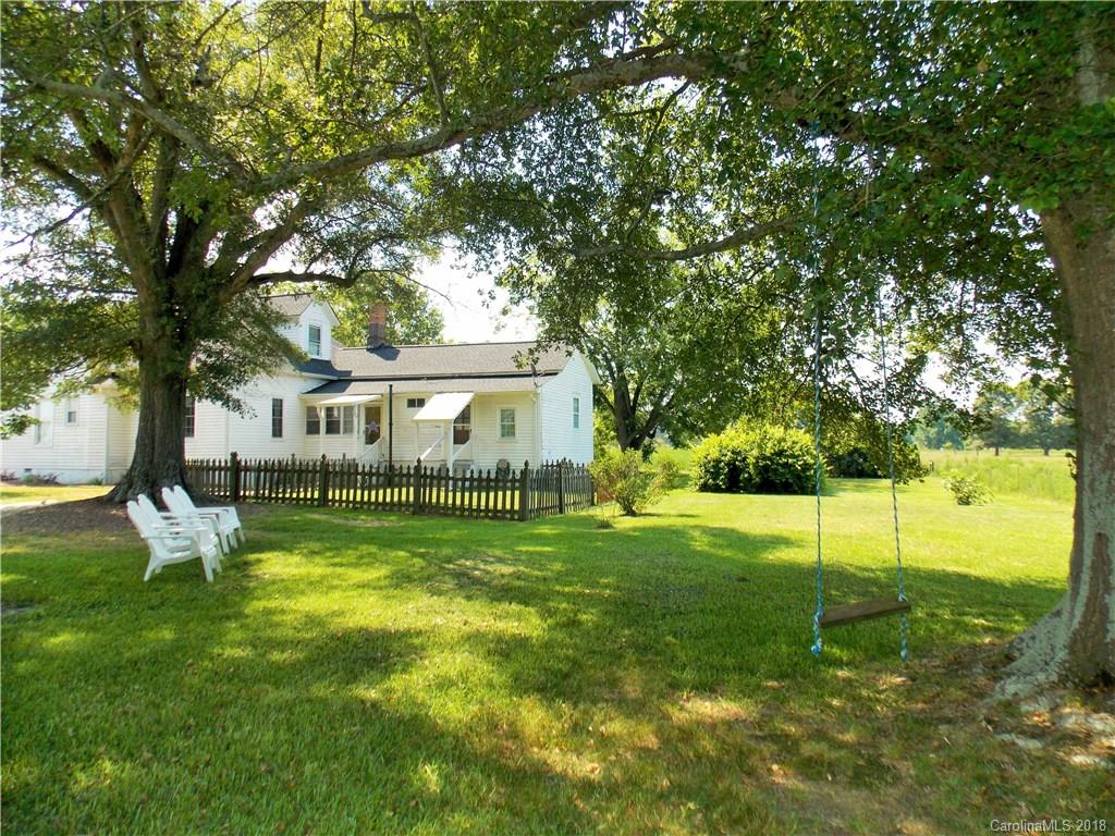3242 South Potter Road Heath Springs, SC 29058 - Photo 25 of 33 a view of a house with a backyard and a tree