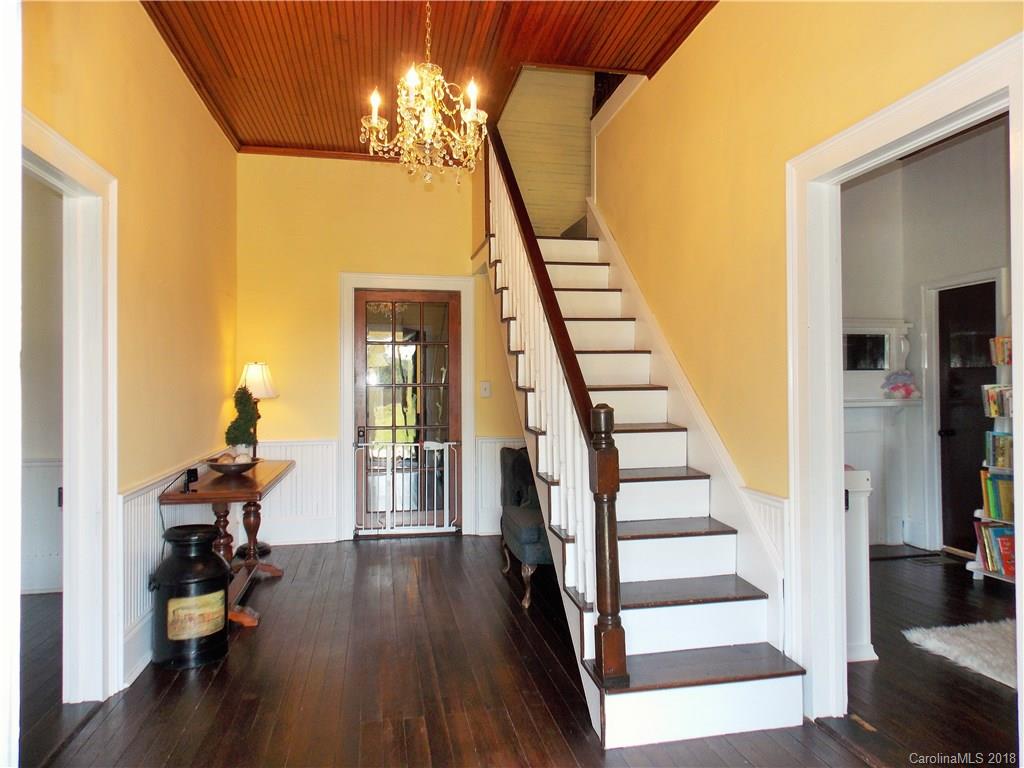 3242 South Potter Road Heath Springs, SC 29058 - Photo 6 of 33 a view of a hallway with wooden floor and staircase