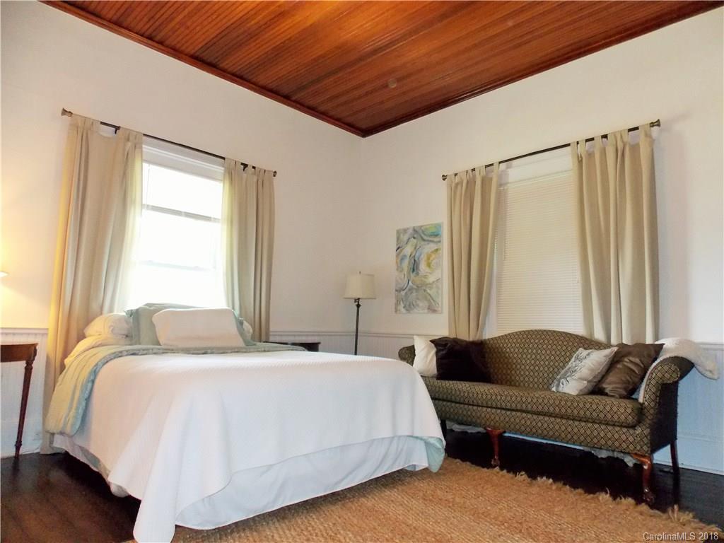 3242 South Potter Road Heath Springs, SC 29058 - Photo 8 of 33 a spacious bedroom with a bed couch and a window