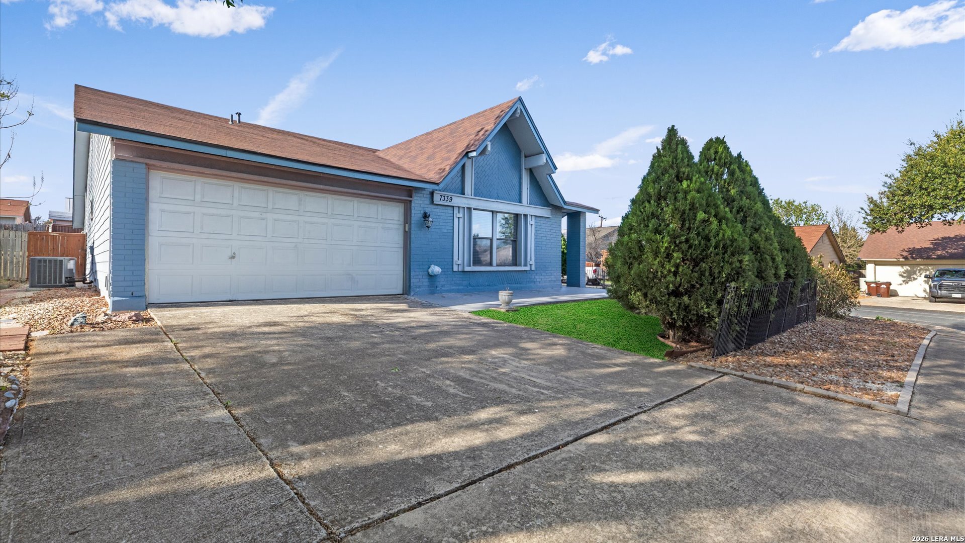 a front view of a house with a garden and entryway