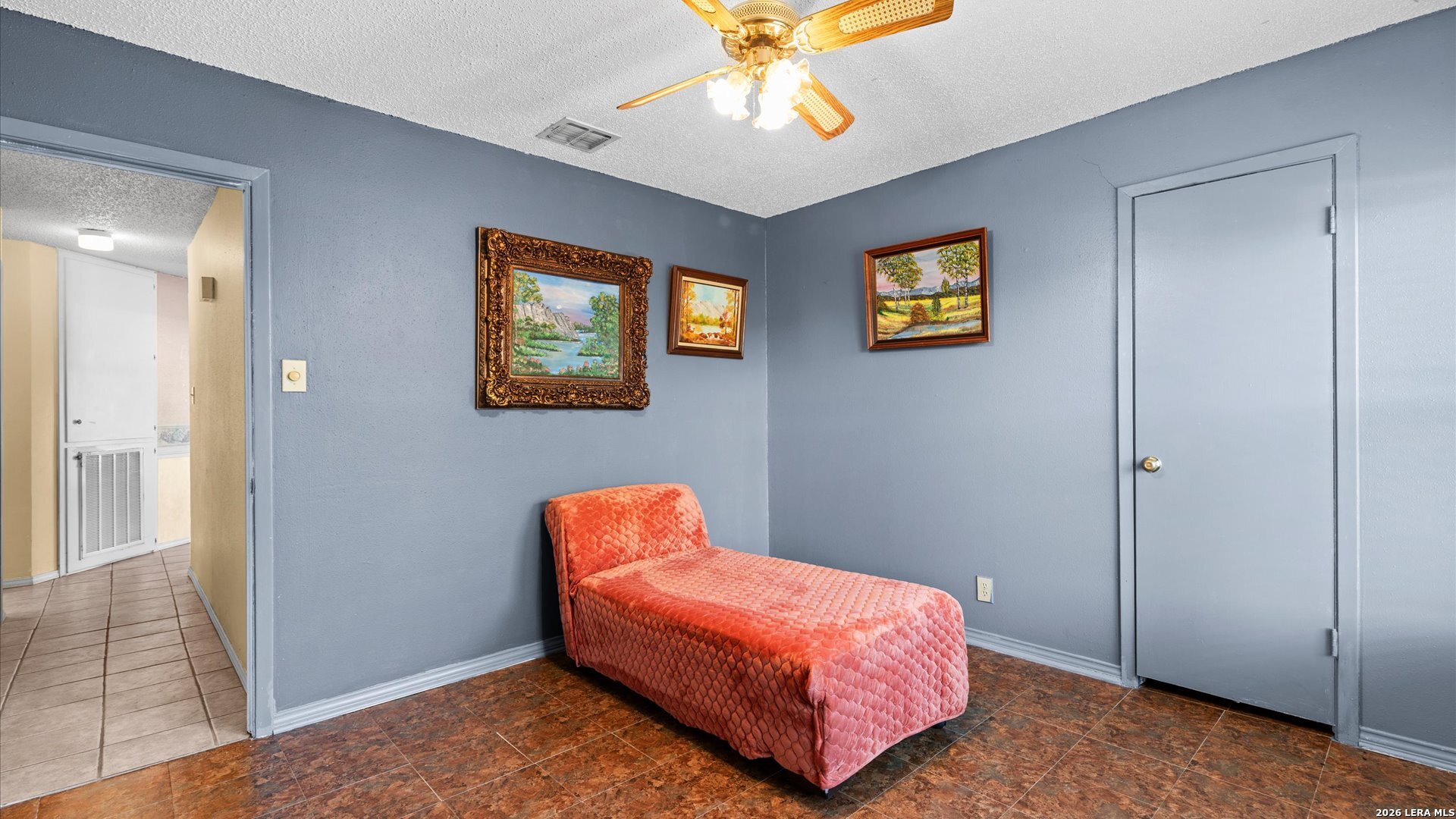 7339 Mystery Ridge Drive Converse, TX 78109 - Photo 17 of 23 a bedroom with a bed and a chandelier