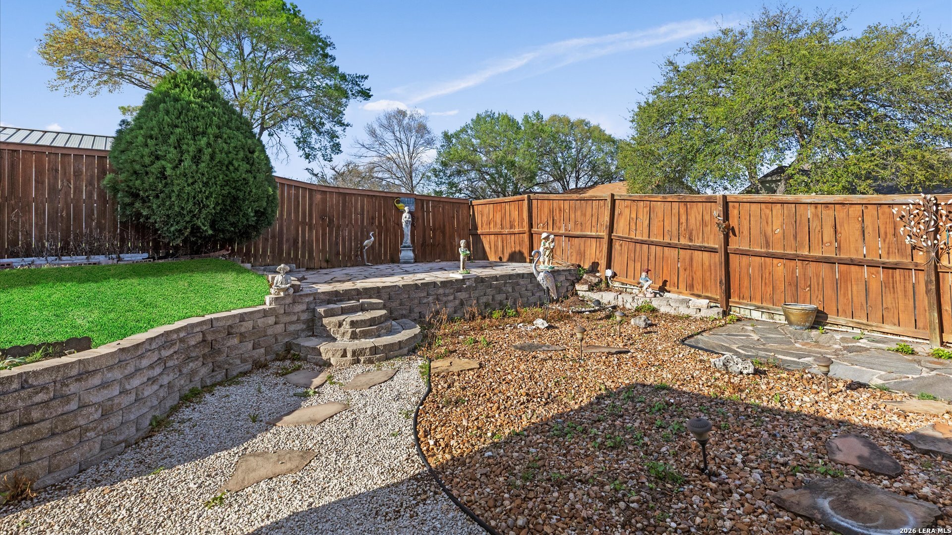 7339 Mystery Ridge Drive Converse, TX 78109 - Photo 20 of 23 a view of a backyard with a large tree and wooden fence