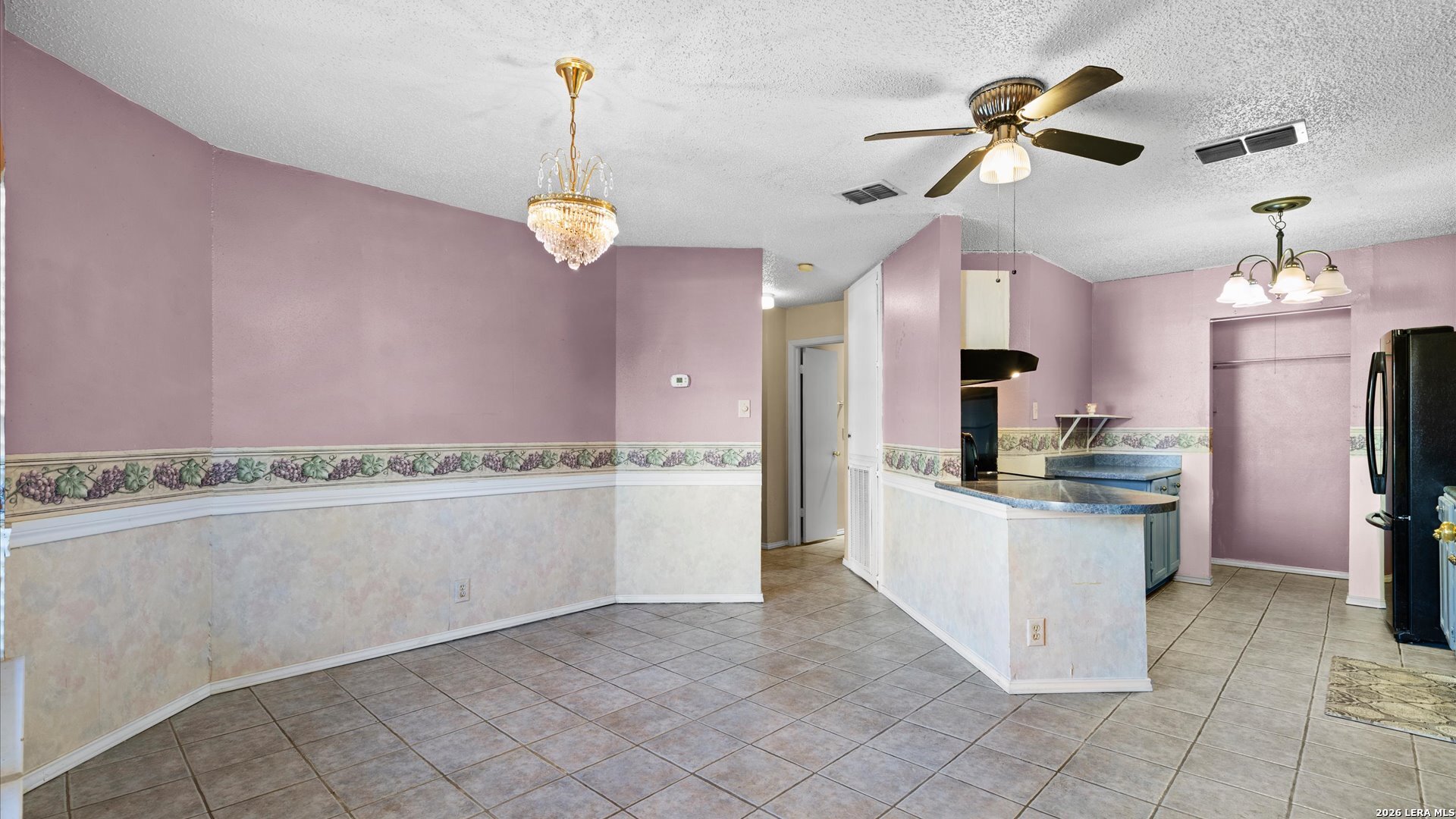 7339 Mystery Ridge Drive Converse, TX 78109 - Photo 3 of 23 a kitchen with kitchen island stainless steel appliances a stove a sink cabinets and a chandelier