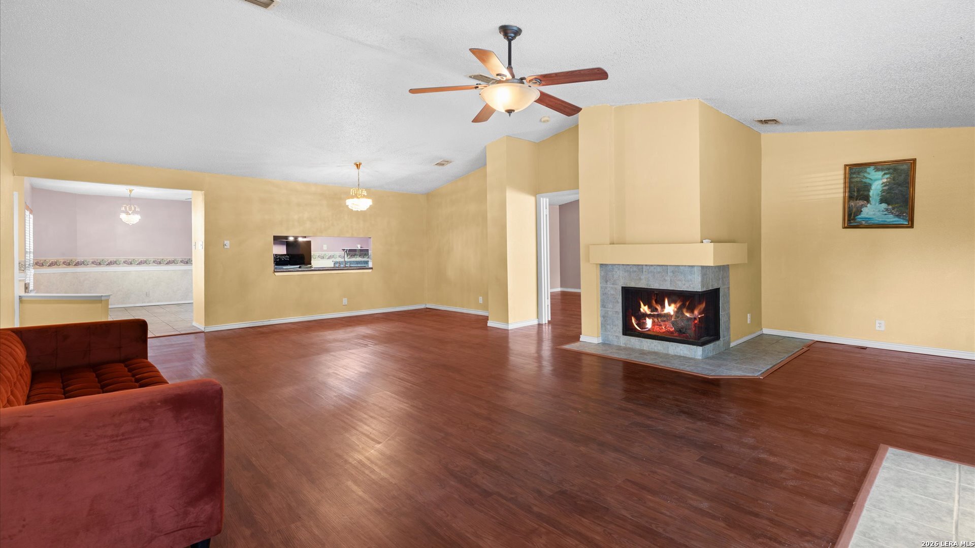 7339 Mystery Ridge Drive Converse, TX 78109 - Photo 5 of 23 a view of a livingroom with a fireplace a ceiling fan and a rug
