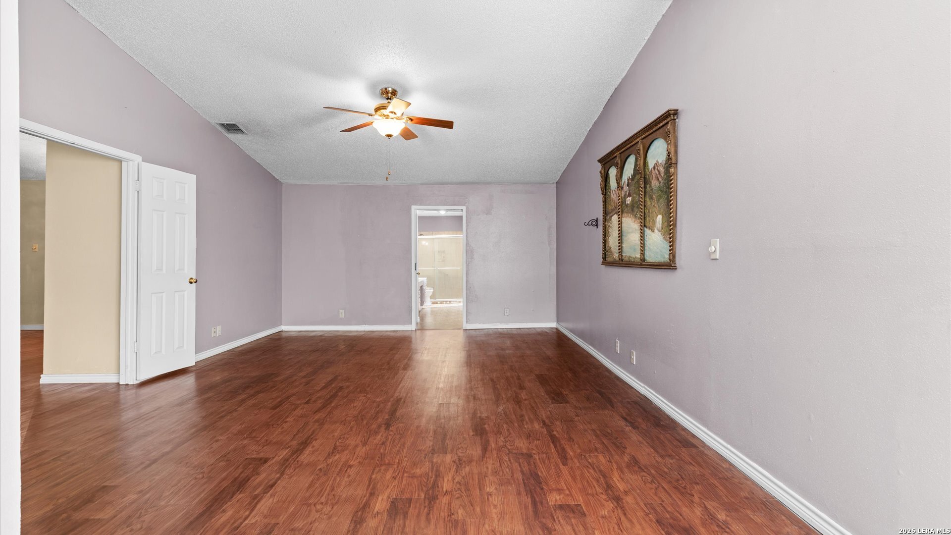 7339 Mystery Ridge Drive Converse, TX 78109 - Photo 8 of 23 a view of an empty room with wooden floor and a window