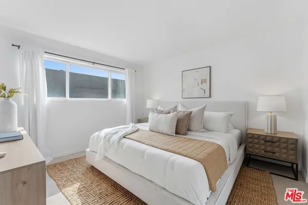 a bedroom with a bed and a night stand