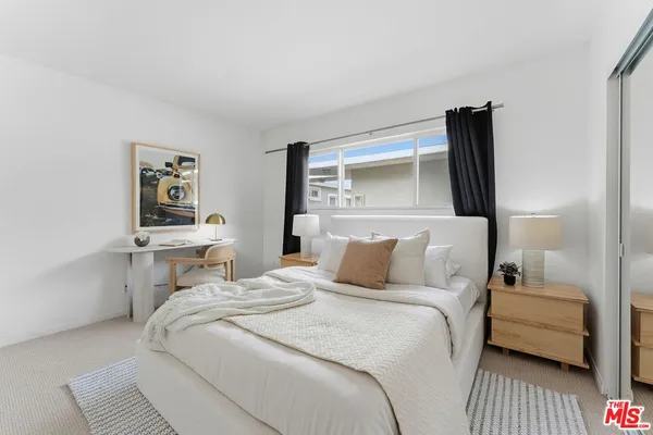 a bedroom with a bed and a night stand