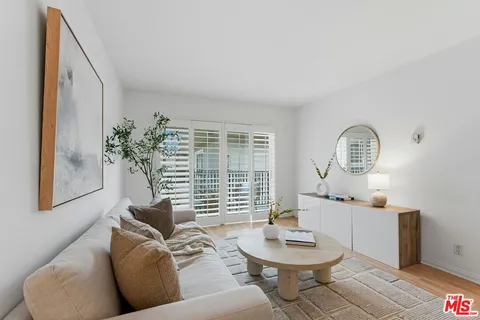a living room with furniture a window and a fireplace
