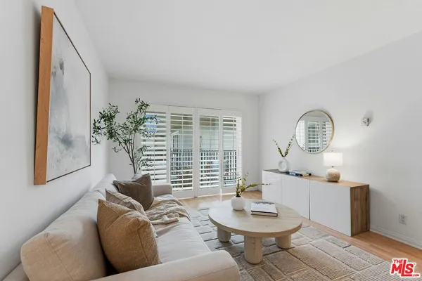 a living room with furniture a window and a fireplace