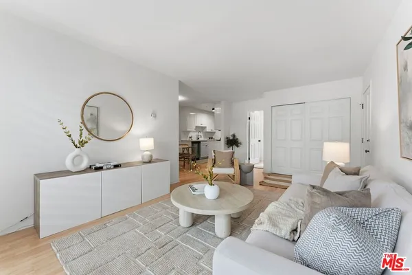 a living room with furniture a mirror and a lamp