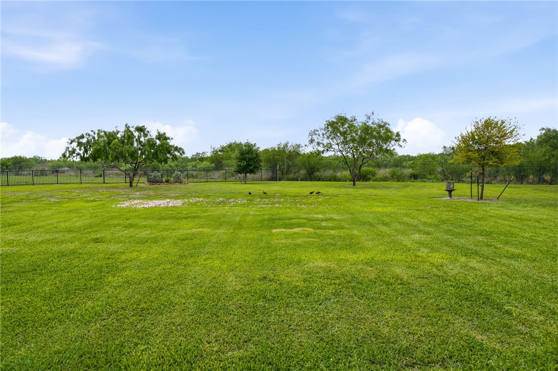 8710 KIng Ranch Drive Corpus Christi, TX 78414 - Photo 37 of 38 a view of a green field with trees in the background