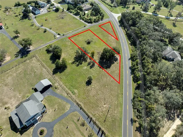 an aerial view of a pool a yard and mountain view