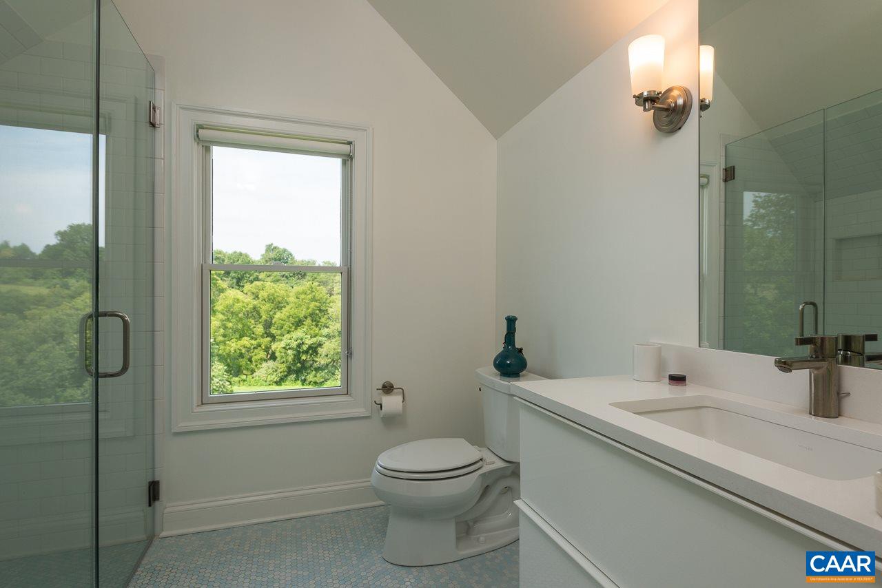 3520 Rocks Mill Lane Charlottesville, VA 22903 - Photo 27 of 50 a bathroom with a granite countertop sink toilet a mirror and shower