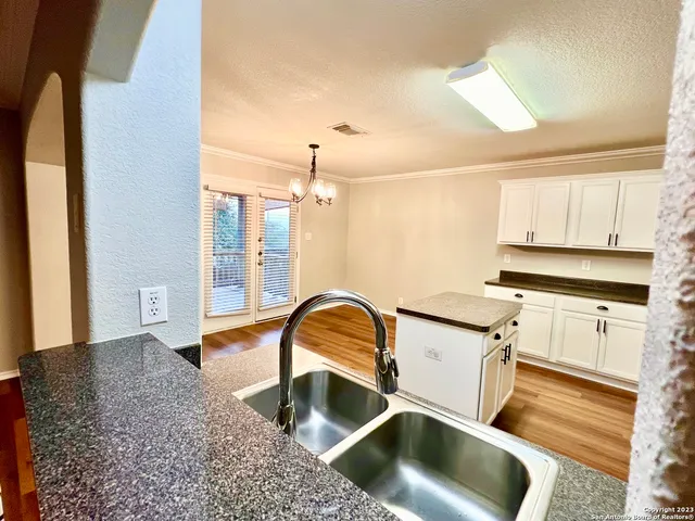 a kitchen with a sink and a stove top oven