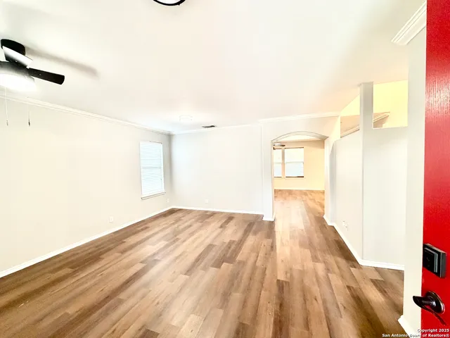 a view of a room with wooden floor