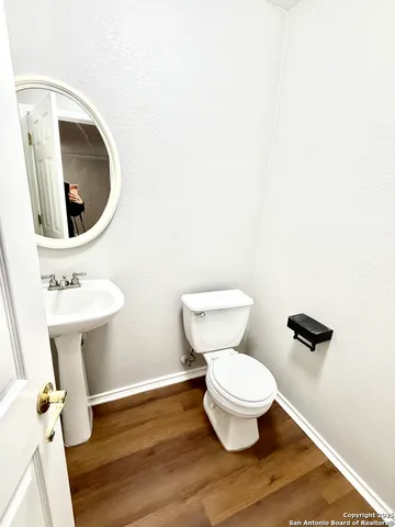 a white toilet sitting next to a bathroom sink