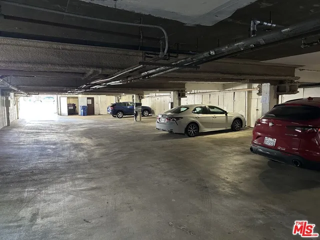 a view of parking garage with cars parked