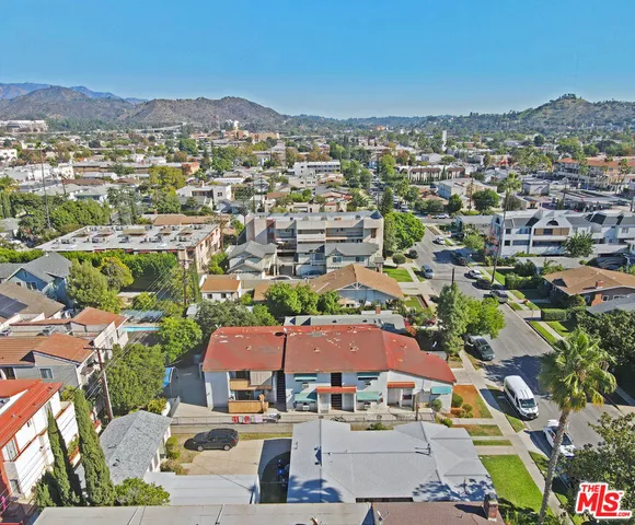 an aerial view of residential houses with city view