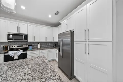 a kitchen with a refrigerator sink and microwave
