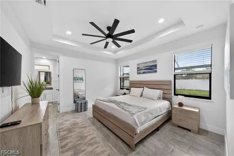 a bedroom with a bed couch and a window