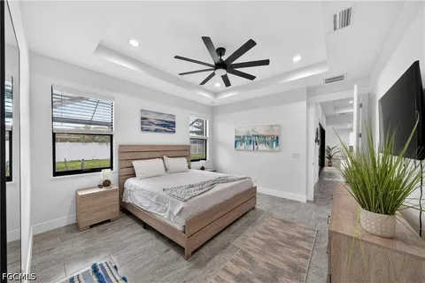a bedroom with a bed and a flat screen tv