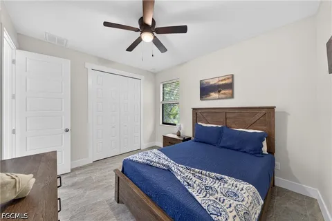 a bedroom with a large bed and a chandelier